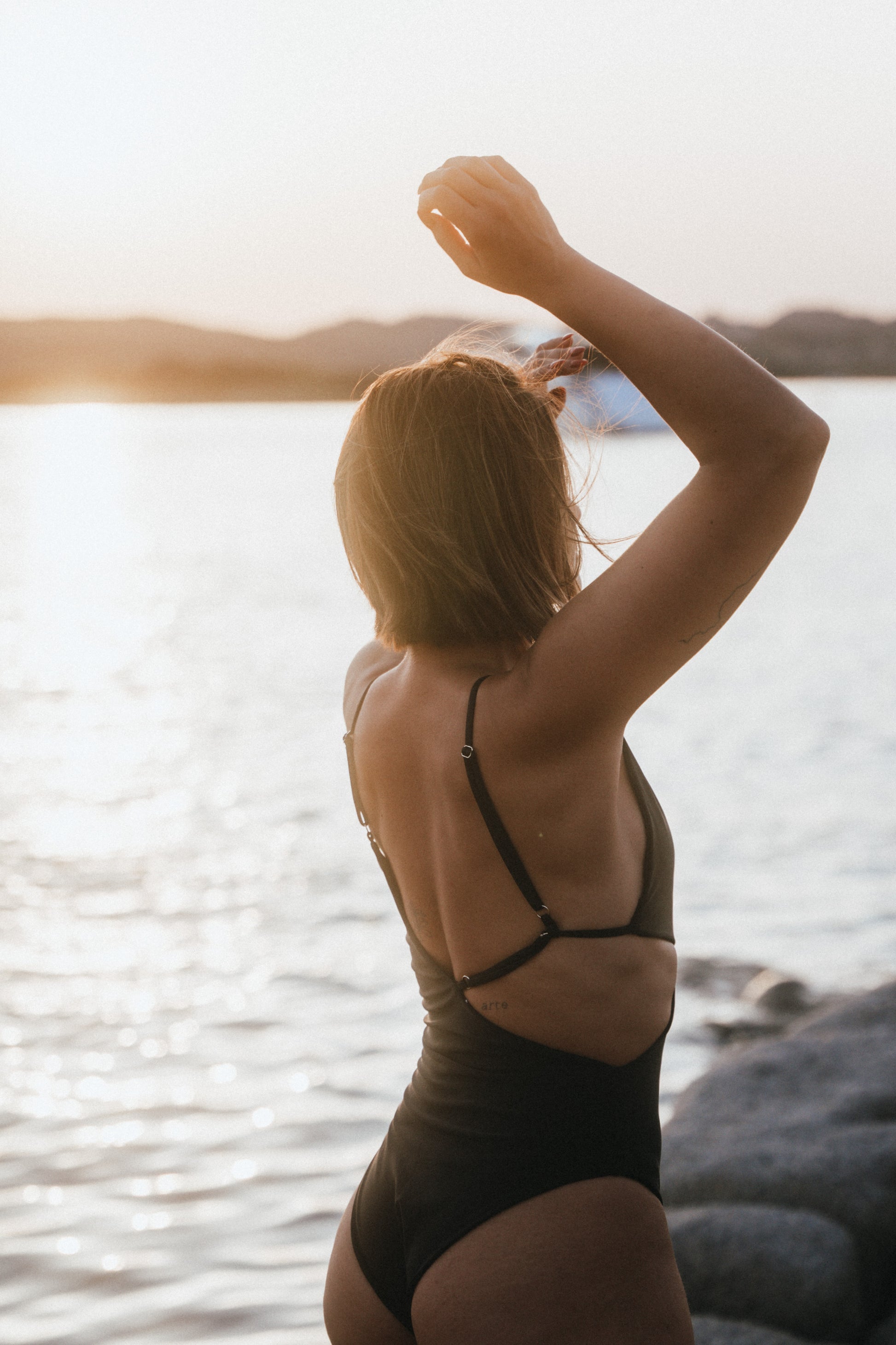 Side-view showing adjustable straps of the Kauai cut-out Black One-piece
