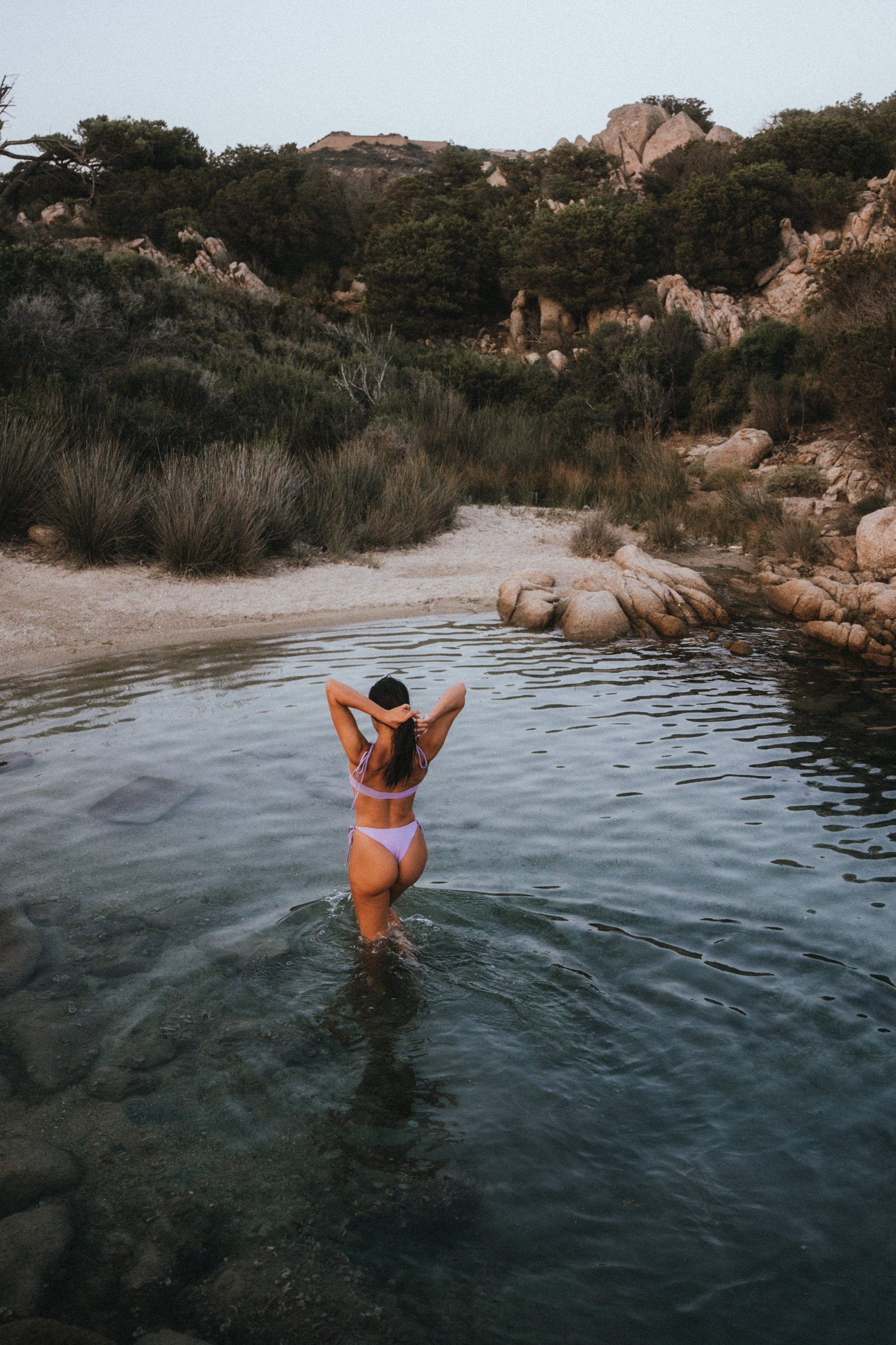 odel wearing the Lolani lavender bikini top and tie bottom in a sunny beach setting